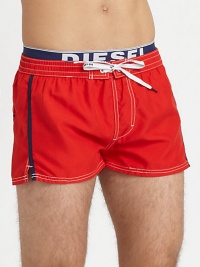 A summer beach essential for the contemporary man, shaped in quick-drying nylon and finished with an elastic logo waistband.Elastic drawstring-tie waistRear patch pocketInseam, about 2PolyesterMachine washImported A summer beach essential for the contemporary man, shaped in quick-drying nylon and finished with an elastic logo waistband.Elastic drawstring-tie waistRear patch pocketInseam, about 2PolyesterMachine washImported