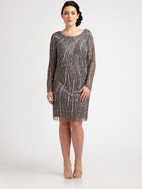 Certainly striking, this sequined shift has a curve-flattering fit. The sexy sheer sleeves offer arm coverage and the plunge back is irresistible. Round neckSheer sleevesPlunge backConcealed back zipperAbout 24 from natural waistPolyesterSpot cleanImported