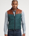 Casual vest adds a layer of warmth and style in this modern combo of leather and nylon.Front zipperSide pocketsLeather shouldersAbout 24 from shoulder to hemPolyamide/polyesterDry clean by leather specialistMade in Italy