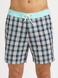 A quick-dry look with yarn-dyed checks revive a classic beach style. Drawstring waistBack flap pocketsMesh liningInseam, about 6PolyesterMachine washImported A quick-dry look with yarn-dyed checks revive a classic beach style. Drawstring waistBack flap pocketsMesh liningInseam, about 6PolyesterMachine washImported