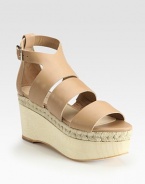 Adjustable, smooth leather straps accompanied by a wooden, espadrille-inspired wedge and platform. Wooden wedge, 3 (75mm)Wooden platform, 2 (50mm)Compares to a 1 heel (25mm)Leather upperLeather liningBuffed leather solePadded insoleImportedOUR FIT MODEL RECOMMENDS ordering true size. 