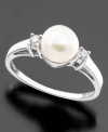 A fantastically beautiful cultured freshwater pearl (7mm) is the centerpiece of this blissful ring featuring round-cut diamonds (1/10 ct. t.w.) set in 14k white gold.
