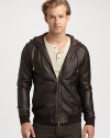A rich leather jacket with a two-way zip front, is a definite wardrobe essential, while an attached hood lends a contemporary edge that is both rugged and refined.Two-way zip frontAttached drawstring hoodWaist slash pocketsBanded cuffs and hemAbout 26 from shoulder to hemLeatherDry cleanImported