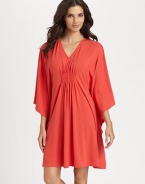 Wide sleeves and center ruching make for a flattering silhouette of soft-stretch fabric. V-neckThree-quarter length wide dolman sleevesCenter ruching for added drapeAbout 36 from shoulder to hem62% polyester/33% rayon/5% spandexMachine washImported