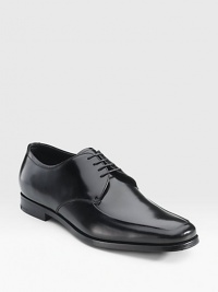 Highly polished Italian spazzolato leather lace-up oxford with an apron toe. Leather lining Padded insole Leather and rubber sole Made in Italy 