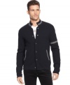 A button-front cardigan that quotes the collegiate with armband and color-tipped handwarmer pockets, from Armani Jeans.