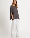 Soft linen boatneck with three-quarter dolman sleeves and an emphasized hi-low hem can be paired with fitted jeans or wide-leg pants for a slouchy-chic look. BoatneckDropped shouldersThree-quarter dolman sleevesDraped hi-low hemLinenDry cleanImportedModel shown is 5'10 (177cm) wearing US size Small.