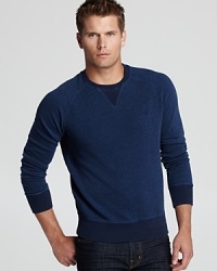 A cozy classic, Fred Perry's crewneck sweatshirt is a study in low-key cool. A cozy classic, Fred Perry's crewneck sweatshirt is a study in low-key cool.