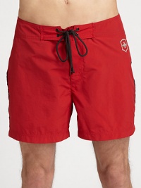 A simple, solid in quick-drying nylon, with multi-colored, striped detail across the back and down the leg.Drawstring tie waistInseam, about 7NylonMachine washImported A simple, solid in quick-drying nylon, with multi-colored, striped detail across the back and down the leg.Drawstring tie waistInseam, about 7NylonMachine washImported