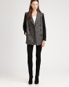 This sophisticated silhouette sports a textural tweed body and cozy knit sleeves