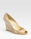From the 24:7 Collection. Elegant patent leather wedge transitions smoothly from office hours through after hours. Self-covered wedge, 3½ (90mm)Patent leather upperLeather liningBuffed leather solePadded insoleMade in ItalyOUR FIT MODEL RECOMMENDS ordering one half size up as this style runs small. 