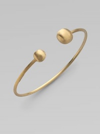 From the Africa Collection. Two 18k yellow gold orbs bookend this open bangle design.18k yellow gold Diameter, about 7 Made in Italy 