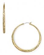 Nail this season's statement earring trend with pair of hoops from ABS by Allen Schwartz, accented by scattered pave crystals.