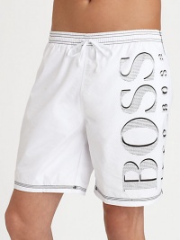 Hit the beach in authentic style in a solid pair with contrast stitching and large BOSS logo.Elastic drawstring waistbandSide slash pocketsInseam, about 7Polyester liningPolyamideMachine washImported Hit the beach in authentic style in a solid pair with contrast stitching and large BOSS logo.Elastic drawstring waistbandSide slash pocketsInseam, about 7Polyester liningPolyamideMachine washImported
