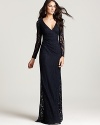 Long sleeves lend a sense of modesty to this otherwise sultry David Meister lace gown.