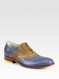 Bold, contrasting colors overtake this classic saddle shoe lending endless style possibilities.Leather upperLeather liningPadded insoleRubber soleImported Bold, contrasting colors overtake this classic saddle shoe lending endless style possibilities.Leather upperLeather liningPadded insoleRubber soleImported