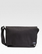 A rugged, everyday look crafted in lasting denier canvas with a convenient laptop compartment. Grip tape closure Exterior zip pocket Interior zip and organizing pockets Laptop compartment Adjustable shoulder strap 18W X 11½H X 5½D Imported 