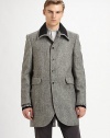 A distinguished wool top coat offering vintage style and modern details.Ribbed-knit detail along collarButton frontPatch pocketsBack ventAbout 35 from shoulder to hemWool; cotton liningMachine washImported