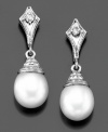Majestic elegance: cultured freshwater pearl (7-7-1/2 mm) drop earrings with shimmering diamond accents in a 14k white gold setting. Approximate length: 3/4 inch.