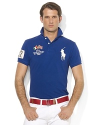 A trim-fitting polo shirt in breathable cotton mesh is finished with bold country details and Ralph Lauren's signature Big Pony. A trim-fitting polo shirt in breathable cotton mesh is finished with bold country details and Ralph Lauren's signature Big Pony.