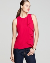 This vividly hued BCBGMAXAZRIA tank flaunts a flouncy ruffled front and striking vented back hem to statement-making effect. This vividly hued BCBGMAXAZRIA tank flaunts a flouncy ruffled front and striking vented back hem to statement-making effect.