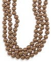 Layer yourself in long and luxurious gold shimmer. Carolee necklace features rich, gold glass pearls (10 mm) set in mixed metal. Approximate length: 72 inches.
