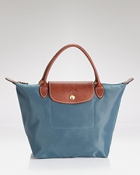 Longchamp's signature nylon tote in a miniature size lends sophisticated chic to every look, from city jaunts to weekend getaways. Folds up for ease during travel. Longchamp's signature nylon tote in a miniature size lends sophisticated chic to every look, from city jaunts to weekend getaways. Folds up for ease during travel.