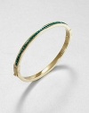 From the Cocktail Collection. Meticulously faceted, emerald-colored stones line one side of this slender bangle, in deep contrast to the other side of polished goldtone.GlassGoldtoneDiameter, about 2.5Hinged with push-lock claspImported
