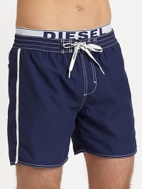 Classic swim trunk style, in quick-drying nylon, finished with a signature elastic logo waistband.Elastic drawstring-tie waistBack patch pocketInseam, about 6PolyesterMachine washImported Classic swim trunk style, in quick-drying nylon, finished with a signature elastic logo waistband.Elastic drawstring-tie waistBack patch pocketInseam, about 6PolyesterMachine washImported