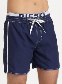 Classic swim trunk style, in quick-drying nylon, finished with a signature elastic logo waistband.Elastic drawstring-tie waistBack patch pocketInseam, about 6PolyesterMachine washImported