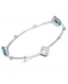 A slim row of sparkle makes a big impact. Victoria Townsend's pretty bangle bracelet slips over the wrist and shines in square-cut blue topaz (10-1/2 ct. t.w.) with diamond accents. Set in sterling silver. Approximate length: 8 inches. Approximate diameter: 2-1/2 inches.