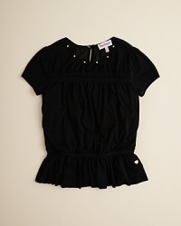 A lovely cap sleeve top is adorned with goldtone studs along the neckline and a ruffled hem with Juicy Couture's signature heart charm. A lovely cap sleeve top is adorned with goldtone studs along the neckline and a ruffled hem with Juicy Couture's signature heart charm.