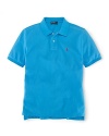 A short-sleeved polo shirt is cut in soft, breathable cotton mesh.