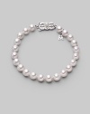 From the Akoya Collection. A simple strand of lustrous white cultured Akoya pearls with a signature filigree clasp. 7mm white, round cultured pearls Quality: A1 18k white gold Length, about 7 Mikimoto signature clasp Imported
