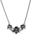 In full bloom. This cute frontal necklace from Fossil features a cluster of three floral pendants embellished with clear crystal stones. Crafted in silver tone mixed metal. Lobster claw closure. Approximate length: 18 inches.