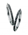Get easy, glamorous style in glittering hoops by GUESS. Earrings feature rows of round-cut jet crystals set in hematite tone mixed metal. Approximate diameter: 1-1/2 inches.