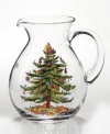An elegant glass pitcher, perfect for holiday eggnog,  featuring Spode's beloved Christmas Tree pattern. A full evergreen tree is impeccably decorated with baubles and tinsel, with gifts placed underneath. Sprigs of holly and ivy complete the scene. Pitcher holds 96 ounces.