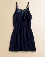 Striking turquoise stones and a ruffled bodice lend a glam look to this smart A-line frock.ScoopneckSpaghetti strapsPullover styleElastic waistFully linedRayonMachine wash on delicateImported