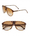 An unique style with a bridge accented with a sleek signature emblem. Available in blonde havana with brown/grey gradient lens. Logo temples100% UV protectionImported