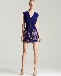 An exposed zip toughens up this richly hued GUESS dress, finished with a floral-print at the skirt for feminine flair. An exposed zip toughens up this richly hued GUESS dress, finished with a floral-print at the skirt for feminine flair.