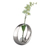 Complete with a white orchid set at a rakish angle, this bud vase combines a round, tapered band of Nambé Alloy and a glass center into an objet d'art suitable for any room in the house. The vase measures 7 inches in diameter. Designed by Neil Cohen.