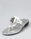 A monogrammed badge showcases Lauren Ralph Lauren's recognizable initials on these gleaming metallic sandals, equipped with a low, practical wedge.