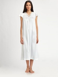 Fluttering cap sleeves lend a touch of romance to this beautiful silhouette, with front shirring and an embroidered neckline. V-neck with embroidered trimShort cap sleevesGathered yokeFront shirringAbout 48 from shoulder to hemPolyesterMachine washImported Fluttering cap sleeves lend a touch of romance to this beautiful silhouette, with front shirring and an embroidered neckline. V-neck with embroidered trimShort cap sleevesGathered yokeFront shirringAbout 48 from shoulder to hemPolyesterMachine washImported