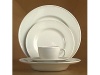 A simple detail inspired by a rolling roulette ball. Made in England. Open stock cream stoneware. Shown: dinner, salad, rim soup, cup and saucer. Microwave and dishwasher safe.