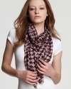 Purple and white houndstooth with BRIT logo decorate this sheer wool scarf from Burberry.