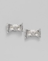 Fluted bows create an ultra feminine look in these silvery studs.Silvertone Width, about ¾ Post back Imported