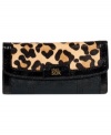 Fulfill your fetish for for exotic accessorizing with this luxe leopard-print design from The Sak. Crafted from supple leather with genuine haircalf and signature detailing, its pocket-lined interior keeps your currency organized and easily at hand.