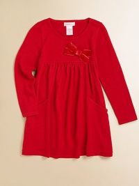 A cozy, cute knit frock with a velveteen bow and front pockets for utility and style.Round necklineLong sleevesPullover styleHigh-waisted with velveteen bowPatch pockets95% viscose/5% spandexHand washImported