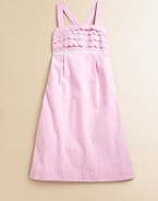 Crafted in preppy seersucker, this classic A-line frock is ultra-glam with scalloped detail, lace trim and smocked back.SquareneckAdjustable straps cross at backScalloped bodicePleated empire waistCottonMachine washImported