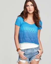 A scallop beaded hem decorates this flirty cropped Free People tee, rendered in a soft burnout fabric--day-ready with love-worn cut-offs and of-the-moment wedges. A scallop beaded hem decorates this flirty cropped Free People tee, rendered in a soft burnout fabric--day-ready with love-worn cut-offs and of-the-moment wedges.